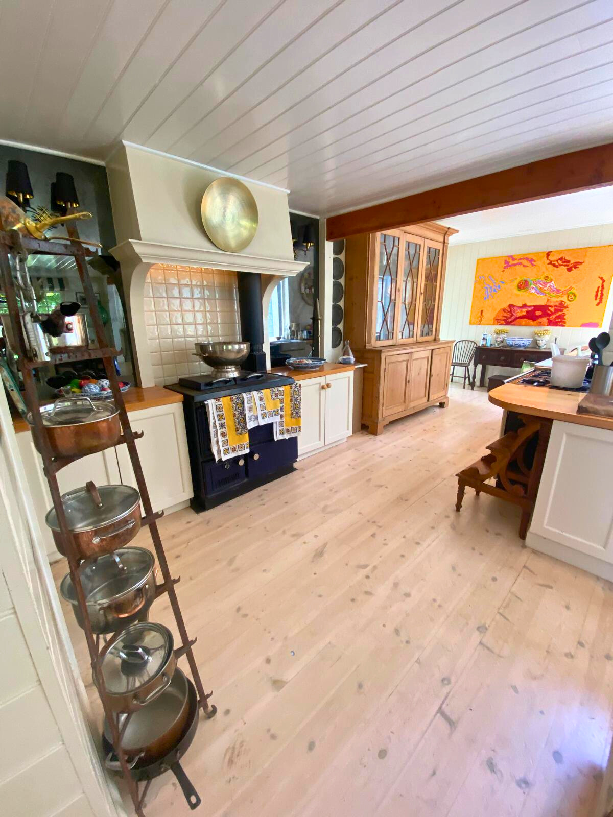 A kitchen with a wooden floor and stove, situated in the Follow Through House facility, highlighting a welcoming environment. A kitchen with a wooden floor and stove, situated in the Follow Through House facility, highlighting a welcoming environment.