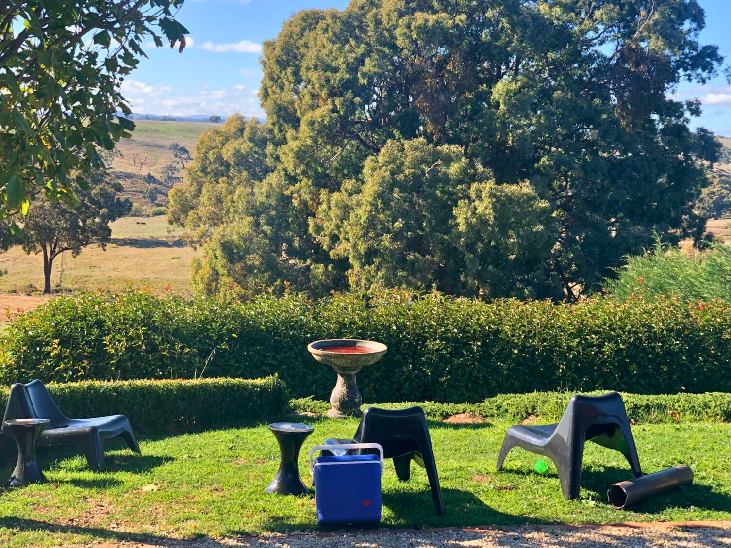 A serene lawn at the Follow Though House facility, featuring chairs and a table for relaxation and gatherings. A serene lawn at the Follow Though House facility, featuring chairs and a table for relaxation and gatherings.