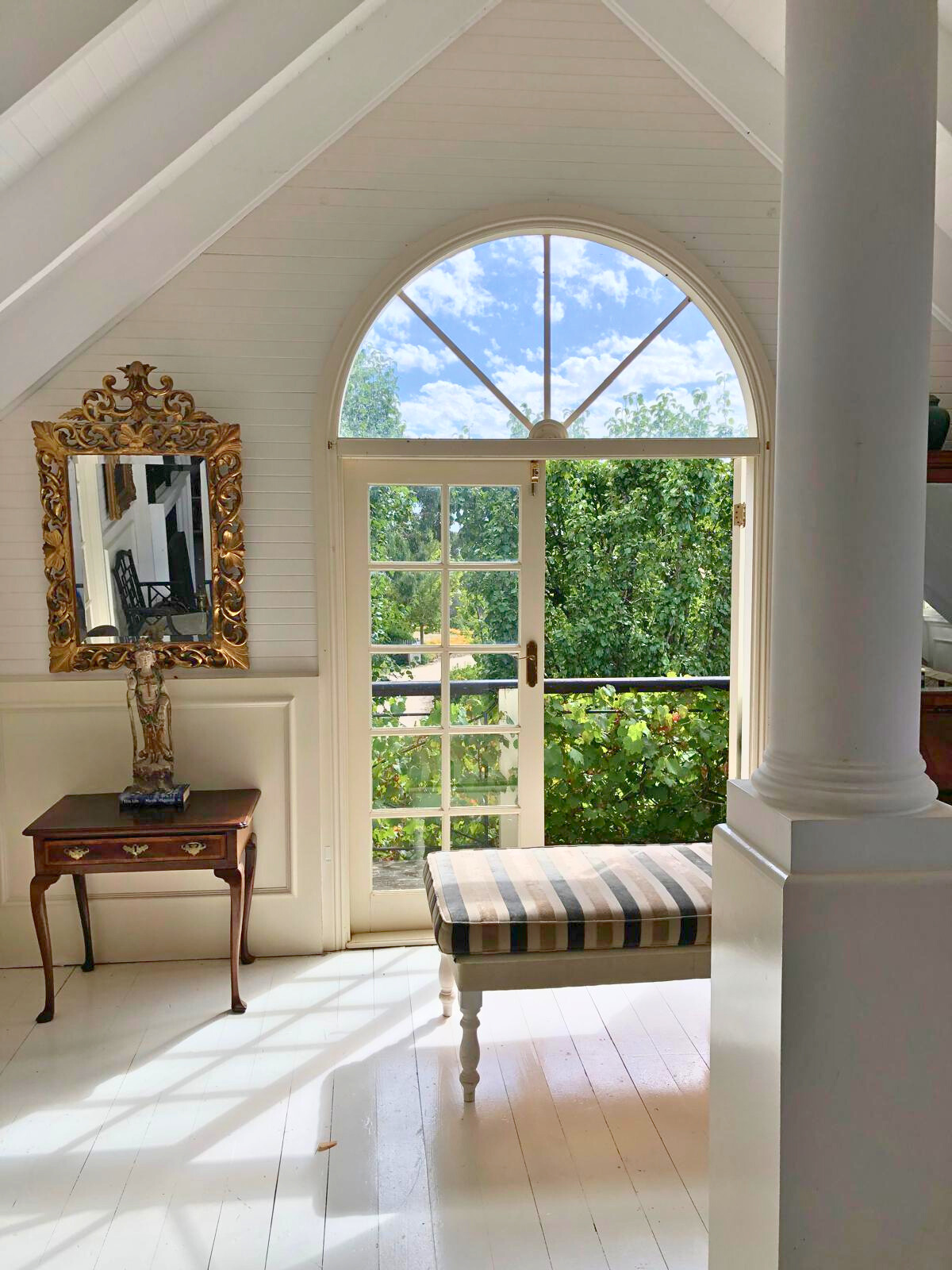 A bright white room featuring a bench and a window, part of the Follow Through House facility. A bright white room featuring a bench and a window, part of the Follow Through House facility.