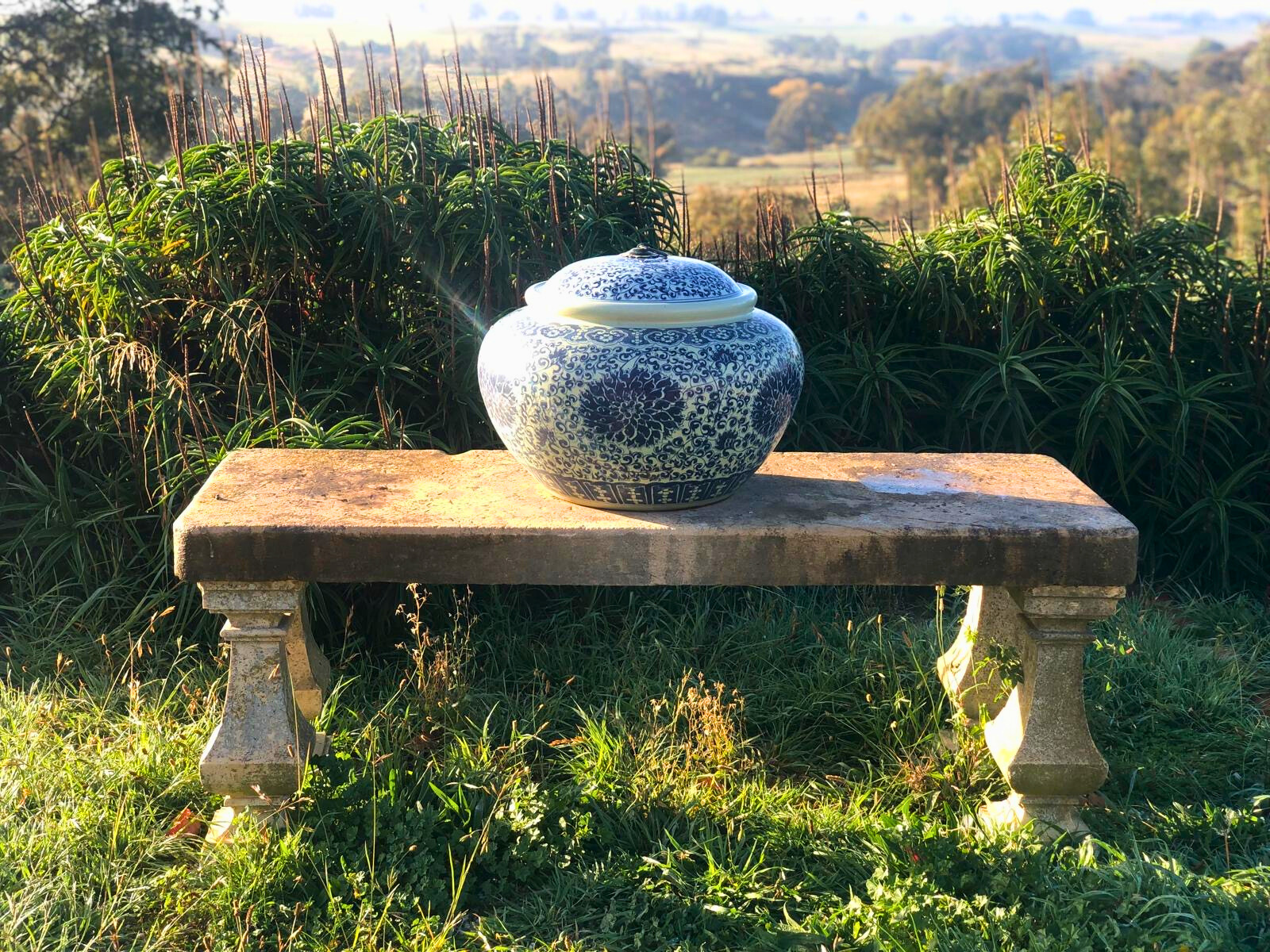 A decorative blue and white vase rests on a bench within the Follow Through House facility. A decorative blue and white vase rests on a bench within the Follow Through House facility.